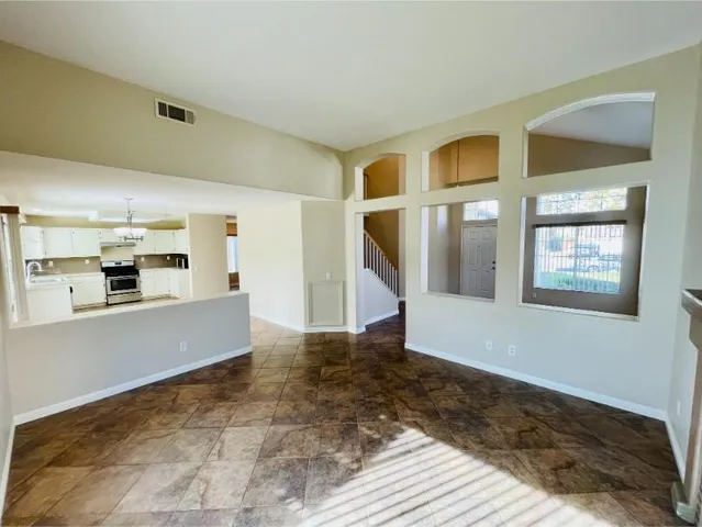 a view of an empty room with window and fire place