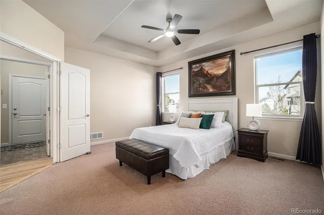 a spacious bedroom with a bed and a ceiling fan