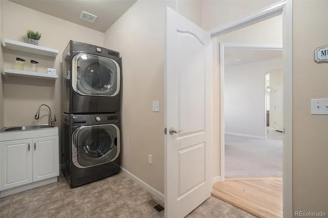 a utility room with sink dryer and washer