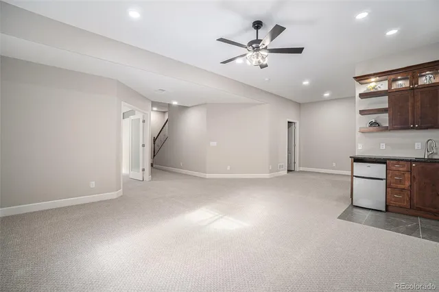 a view of a kitchen with a sink and a ceiling fan