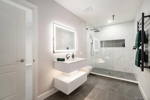 a spacious bathroom with a sink a mirror a bathtub and shower