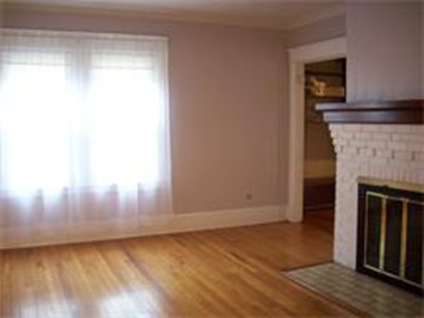 101 Sylvan Street Springfield, MA 01108 - Photo 8 of 29 a view of empty room with wooden floor and fireplace