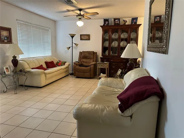 a living room with furniture a dining table and a fireplace