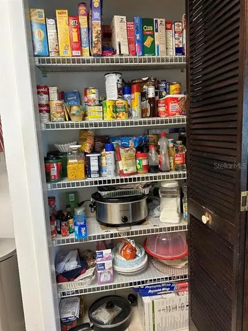 a very nice looking dining room with kitchen island stainless steel appliances a table and chairs