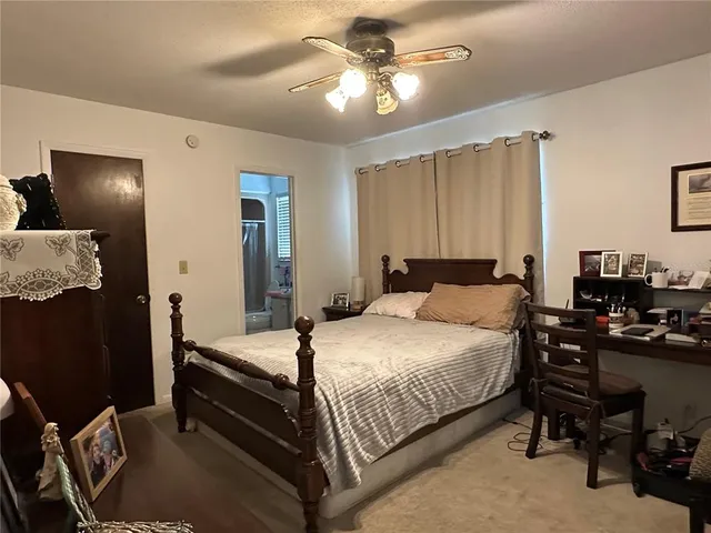 a kitchen with stainless steel appliances kitchen island granite countertop a sink a refrigerator and a stove