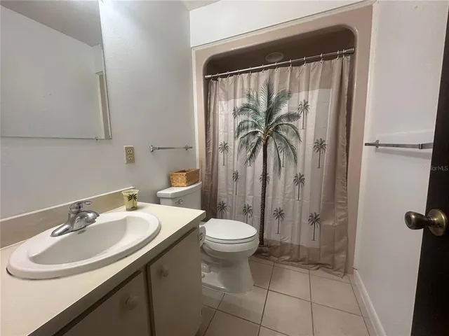 a view of a chair and table in backyard of the house
