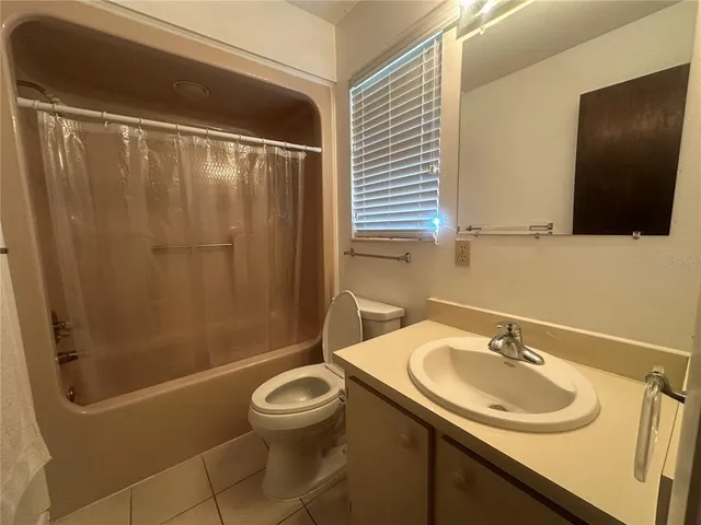 a view of a backyard with a garden and tree