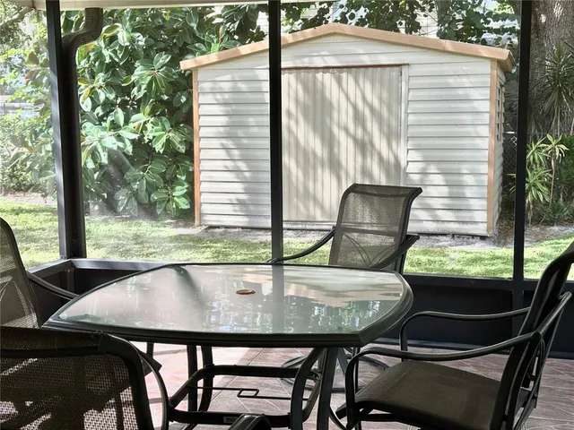 a view of a chair and table in backyard of the house