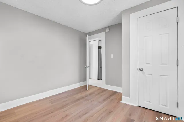 a view of an empty room and wooden floor