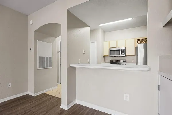 a kitchen with stainless steel appliances a refrigerator sink and microwave