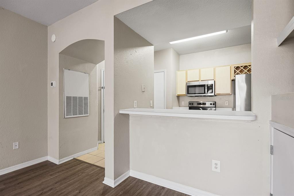8513 Lucuya Way, Unit 209 Temple Terrace, FL 33637 - Photo 11 of 21 a kitchen with stainless steel appliances a refrigerator sink and microwave