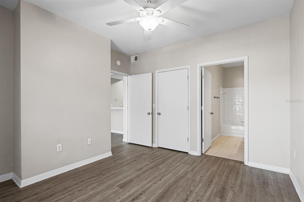 8513 Lucuya Way, Unit 209 Temple Terrace, FL 33637 - Photo 17 of 21 an empty room with wooden floor and door