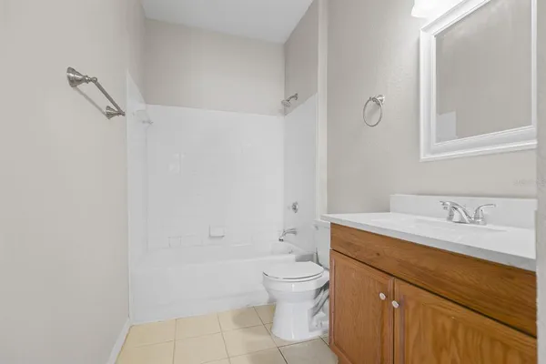 a bathroom with a granite countertop sink toilet a mirror and shower