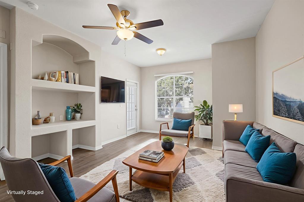 8513 Lucuya Way, Unit 209 Temple Terrace, FL 33637 - Photo 5 of 21 a living room with furniture a flat screen tv and a window
