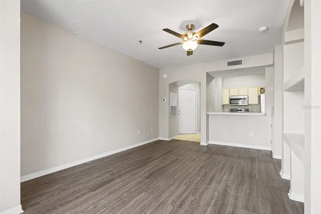 a view of a kitchen with wooden floor and a kitchen