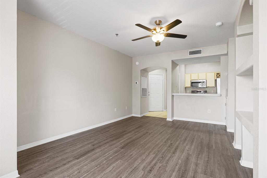 8513 Lucuya Way, Unit 209 Temple Terrace, FL 33637 - Photo 8 of 21 a view of a kitchen with wooden floor and a kitchen