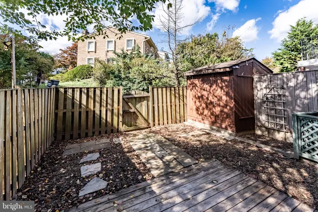 a backyard of a house with barbeque oven and outdoor seating