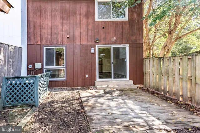 a view of garden with wooden fence