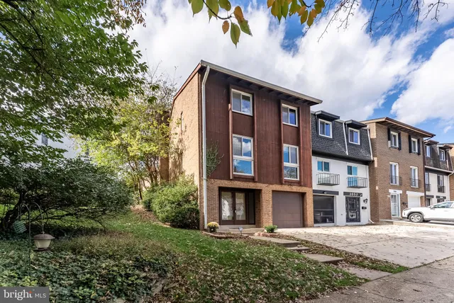 a living room with furniture large window and wooden floor