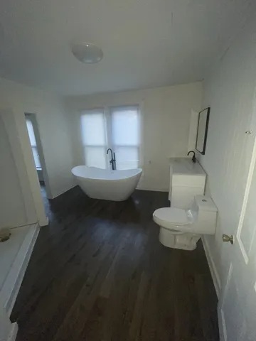 a bathroom with a sink mirror and toilet
