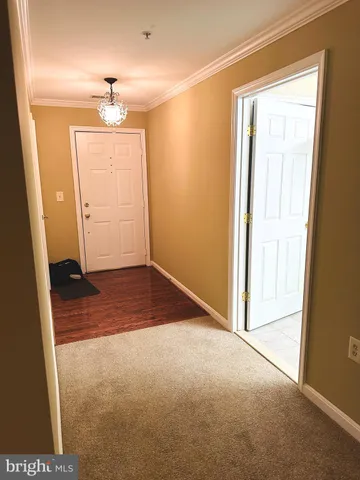 an empty room with closet and windows
