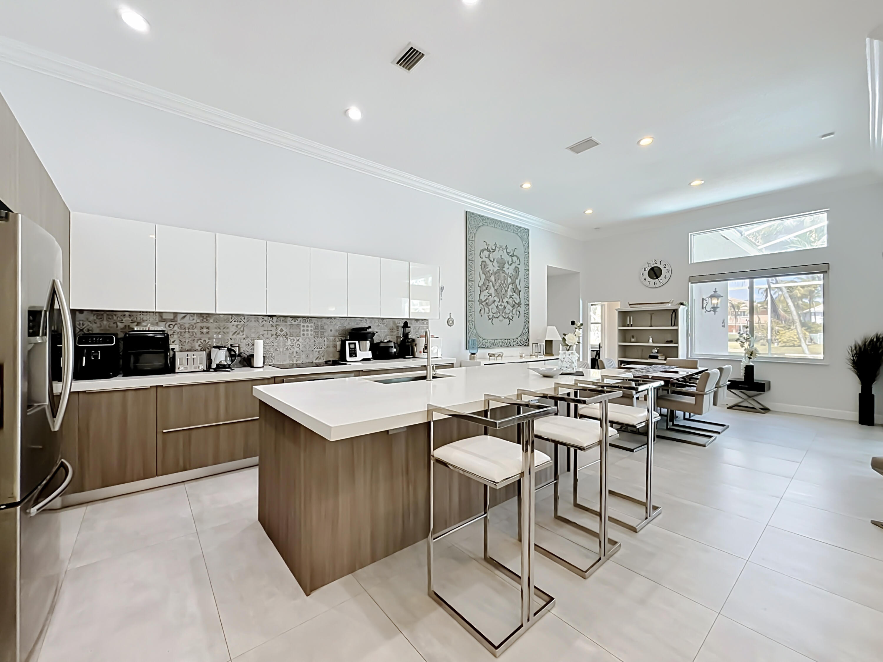 3836 Heron Ridge Lane Weston, FL 33331 - Photo 14 of 71 a kitchen with a sink a counter top space and stainless steel appliances