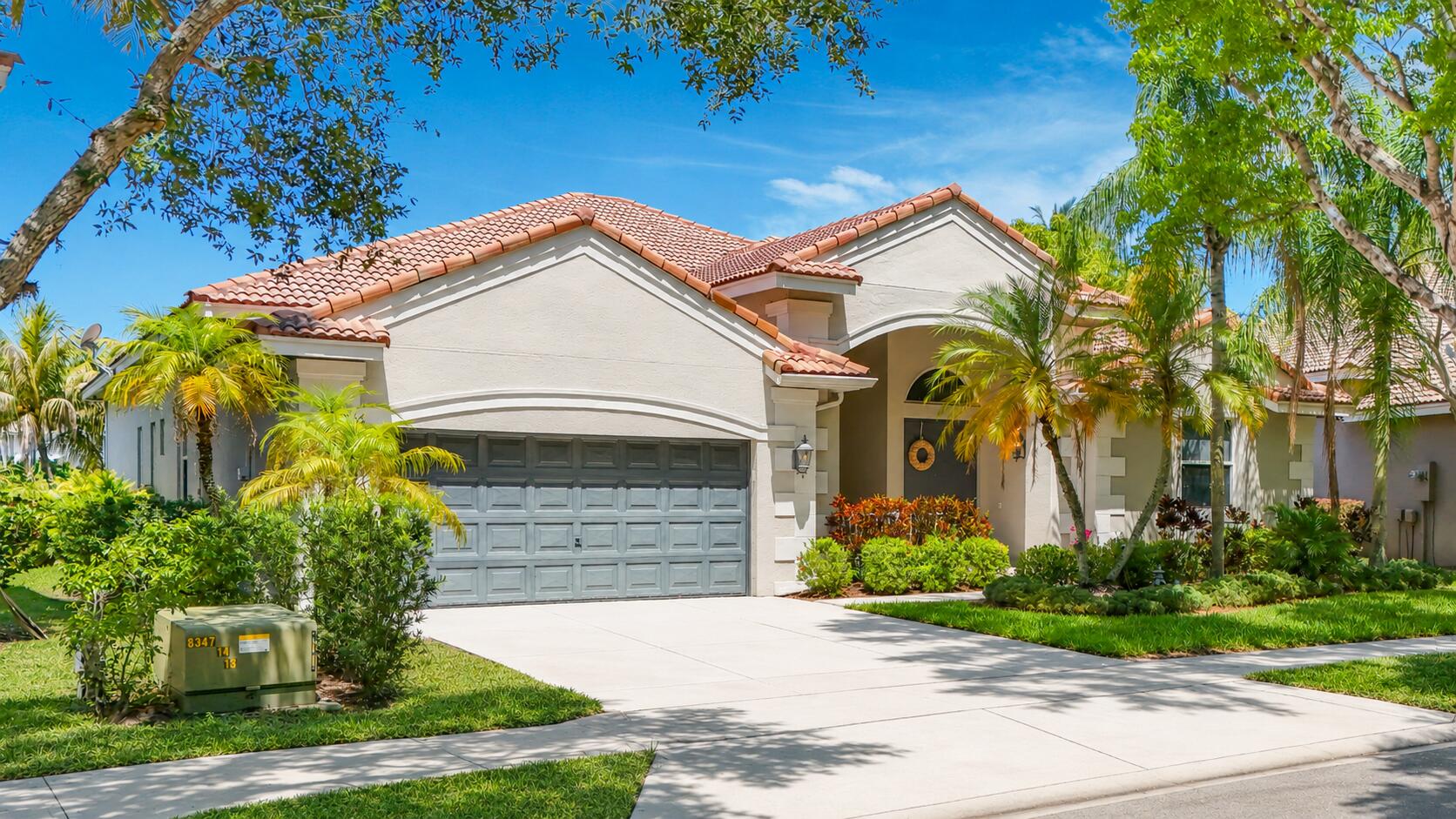 3836 Heron Ridge Lane Weston, FL 33331 - Photo 2 of 71 a front view of a house with garden