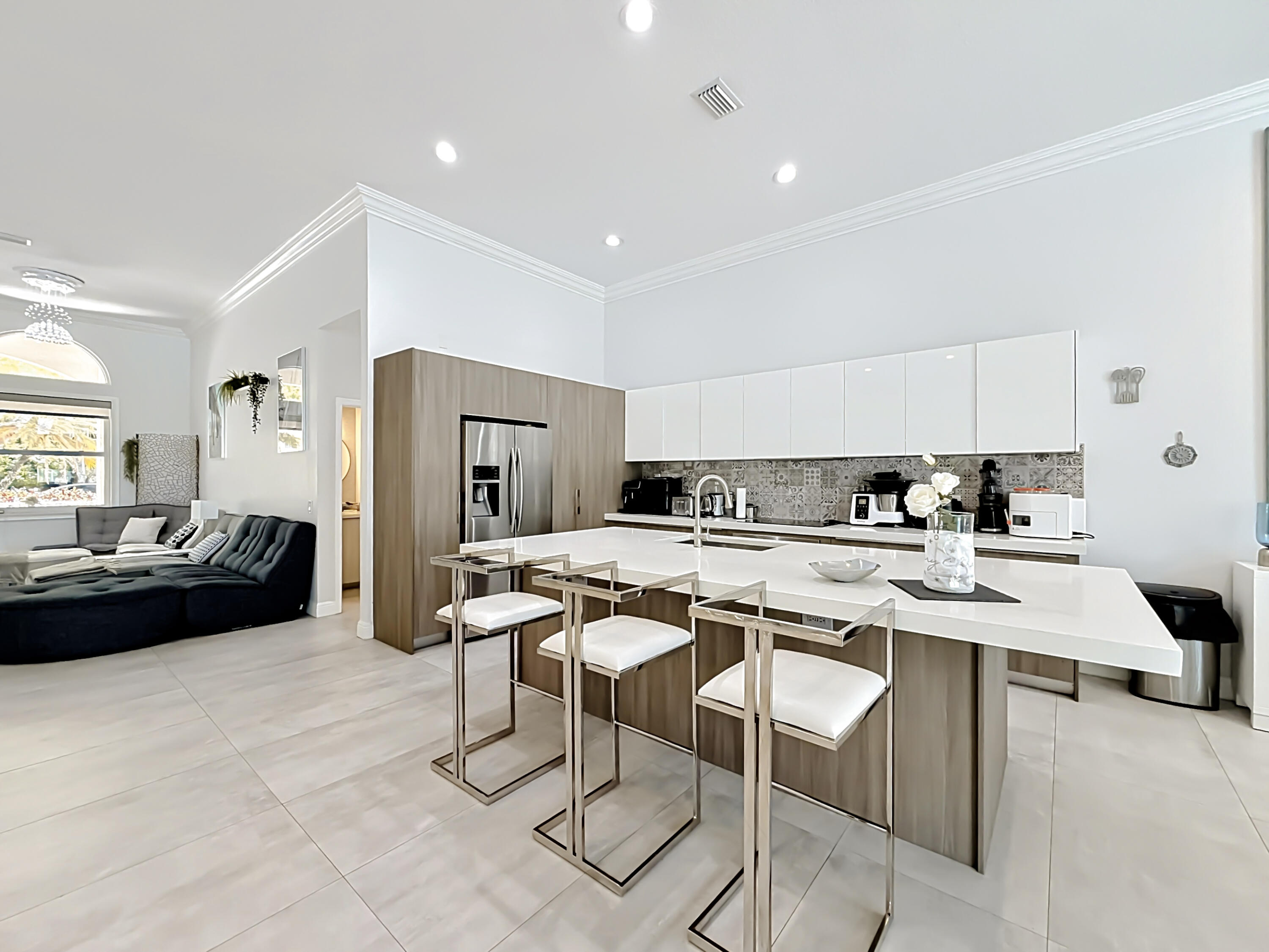 3836 Heron Ridge Lane Weston, FL 33331 - Photo 21 of 71 a kitchen with a sink a stove a refrigerator and chairs