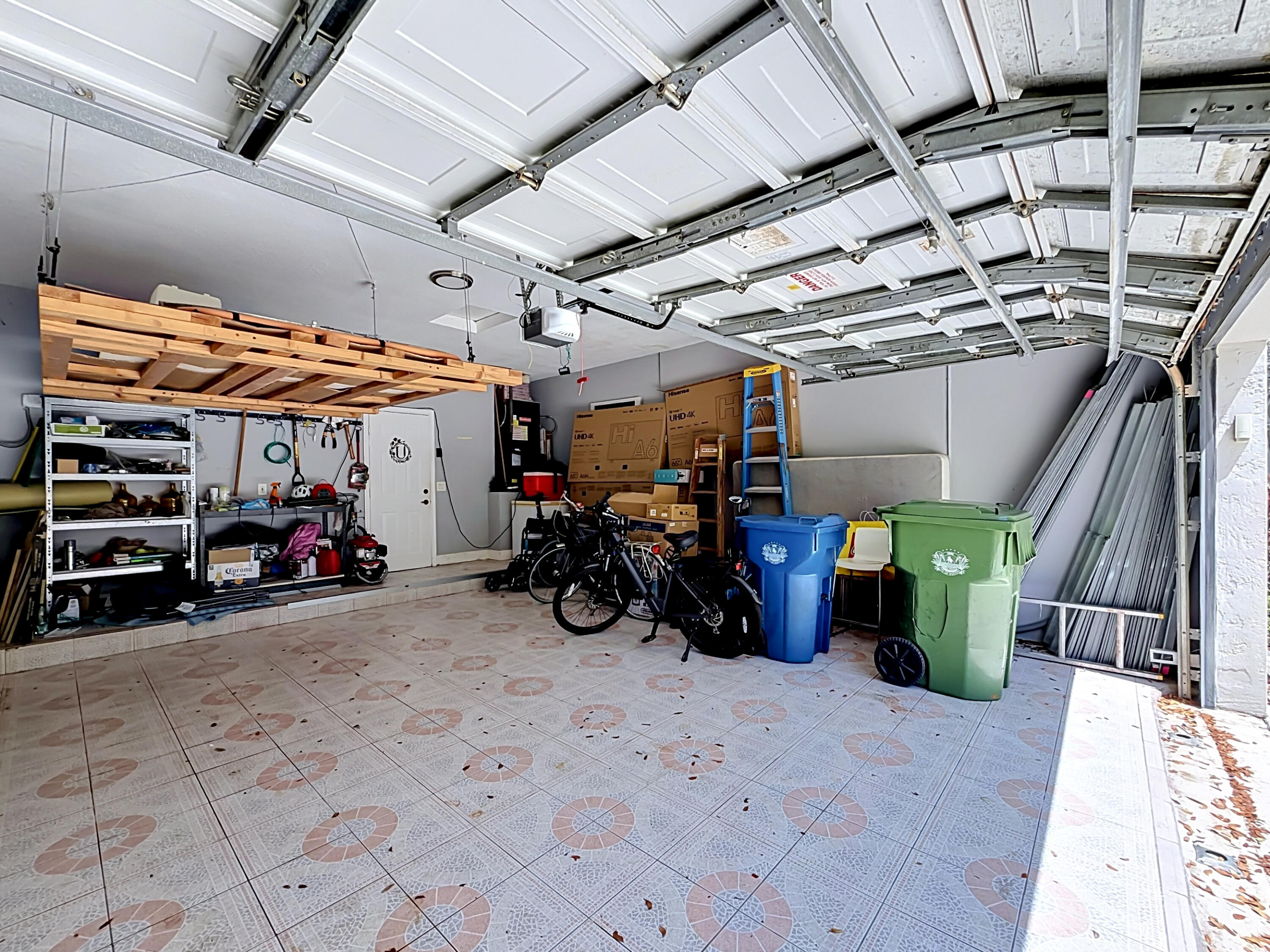 3836 Heron Ridge Lane Weston, FL 33331 - Photo 53 of 71 a view of a garage with a bike and white car