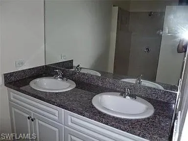a view of a hallway and a bathroom with a sink