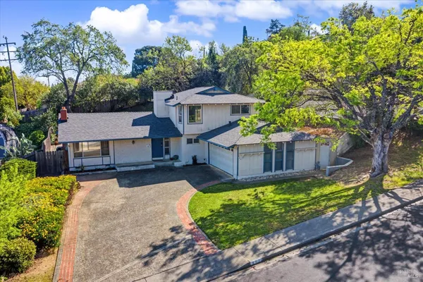 a view of a house with a yard and sitting area
