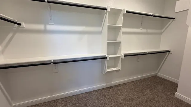 an empty room with windows and entrance