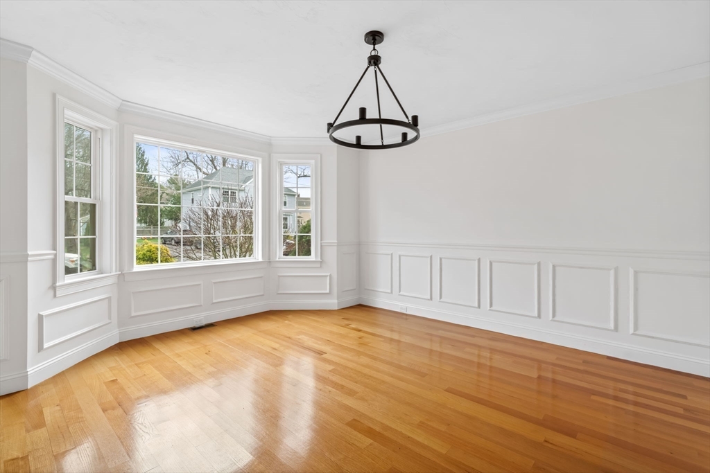 30 Neponset Street Walpole, MA 02071 - Photo 8 of 41 a view of an empty room with chandelier fan and wooden floor