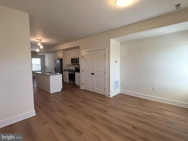 a view of a kitchen with a sink and a refrigerator