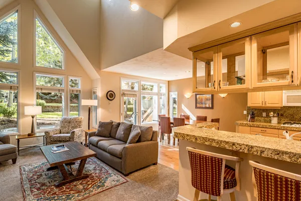 a living room with fireplace furniture and a large window