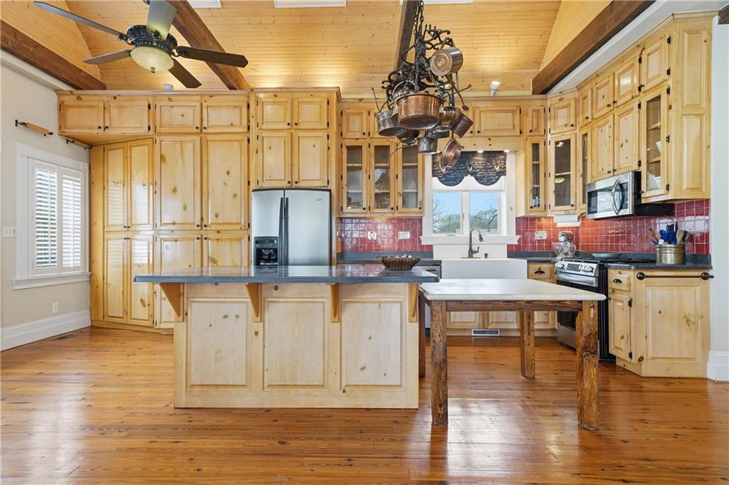 880 Johnstonville Road Barnesville, GA 30204 - Photo 10 of 33 a kitchen with stainless steel appliances granite countertop a white cabinets and wooden floor