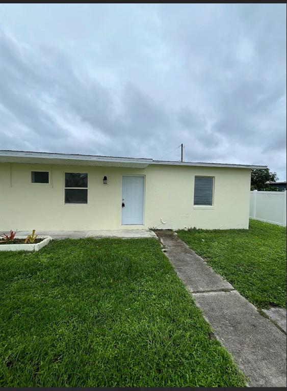 2270 Aaron Street, Unit B Port Charlotte, FL 33952 - Photo 1 of 12 a house view with a garden space