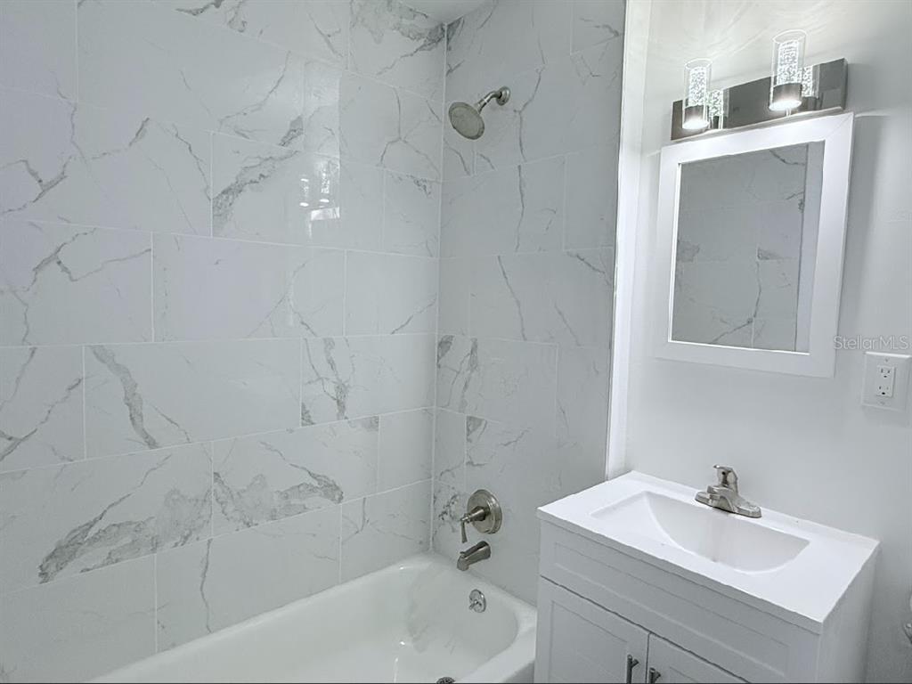 2270 Aaron Street, Unit B Port Charlotte, FL 33952 - Photo 11 of 12 a bathroom with a sink a toilet and shower