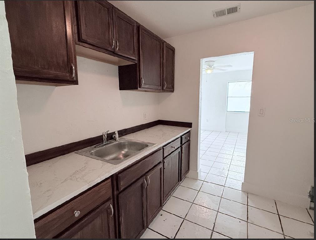 2270 Aaron Street, Unit B Port Charlotte, FL 33952 - Photo 4 of 12 a kitchen with a sink and cabinets