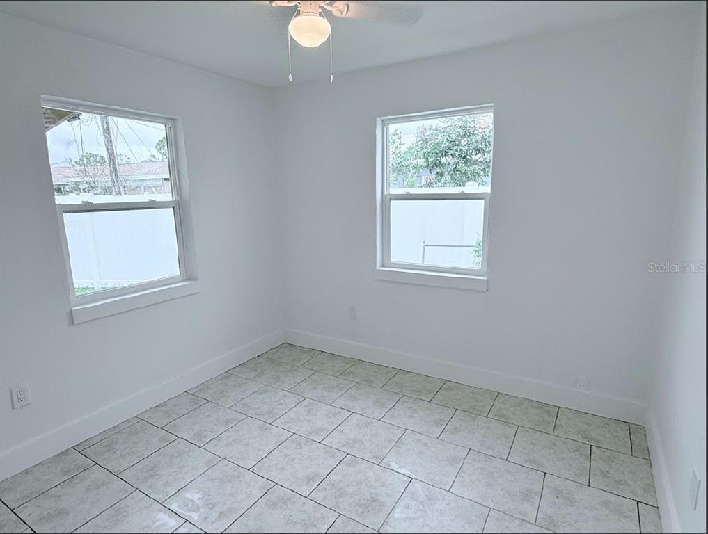 2270 Aaron Street, Unit B Port Charlotte, FL 33952 - Photo 7 of 12 an empty room with windows