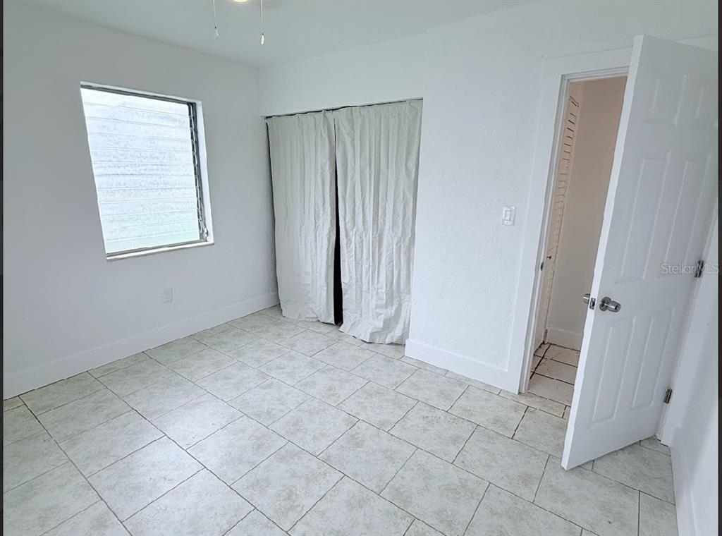 2270 Aaron Street, Unit B Port Charlotte, FL 33952 - Photo 8 of 12 an empty room with windows