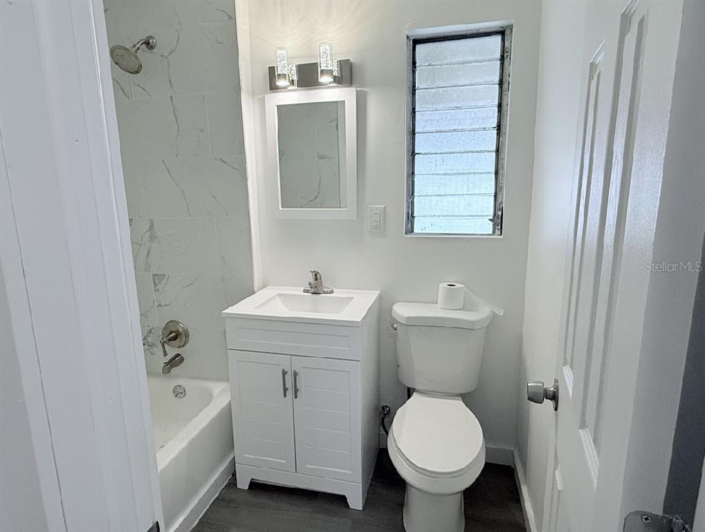 2270 Aaron Street, Unit B Port Charlotte, FL 33952 - Photo 10 of 12 a bathroom with a sink a toilet and shower