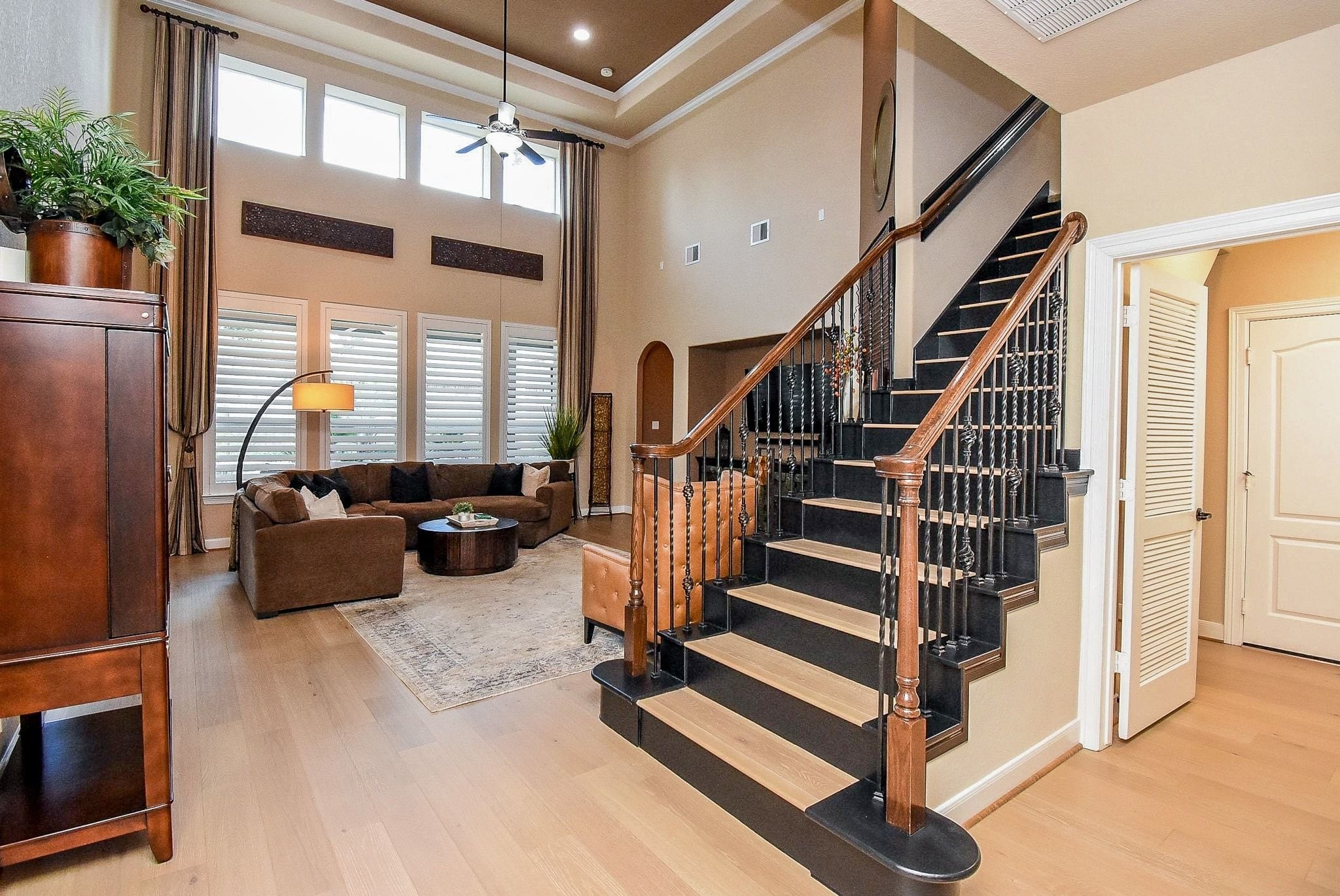 27607 Macklind Ridge Lane Katy, TX 77494 - Photo 19 of 50 Engineered wood floors through main living areas and also on the stairs to bring elegance and easy maintenance. Great 2 story windows to bring in the natural light. Coffered ceilings with crown molding. Wrought iron balusters.