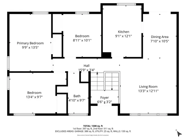 a view of a white house with a large tree and wooden fence