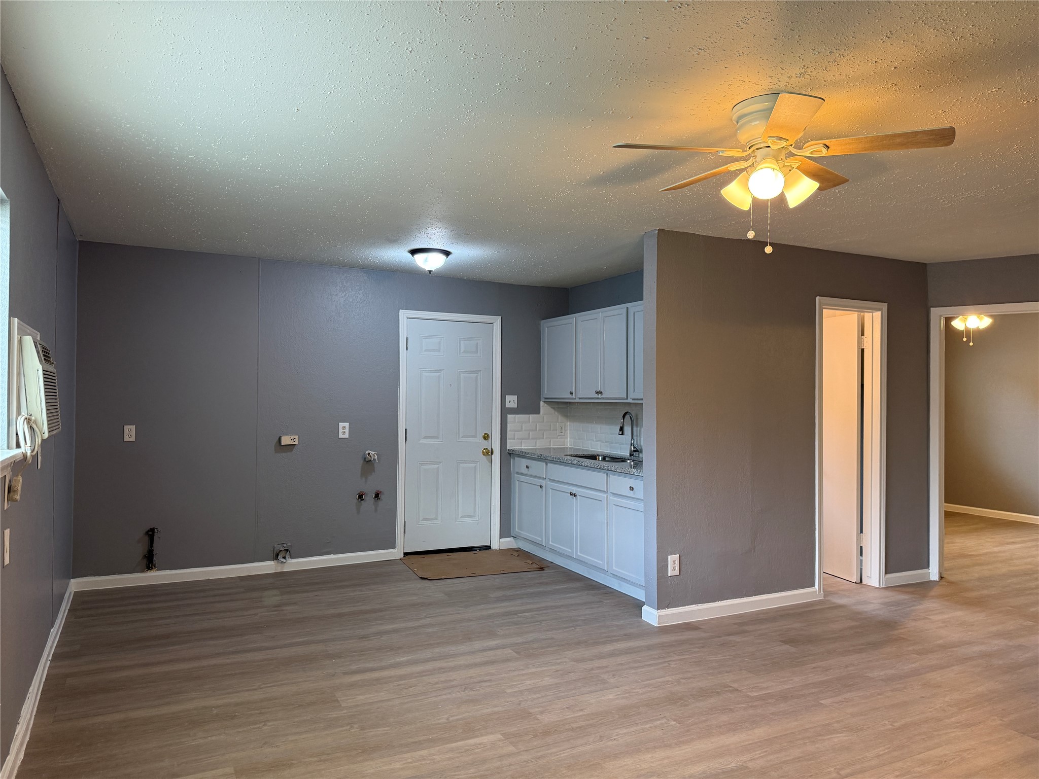 8010 Roswell Street, Unit 3 Houston, TX 77022 - Photo 1 of 12 a view of a kitchen with a sink and a chandelier fan