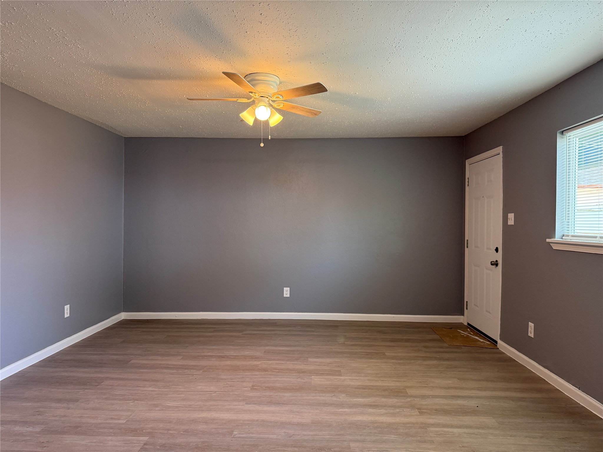 8010 Roswell Street, Unit 3 Houston, TX 77022 - Photo 2 of 12 a view of an empty room with window and wooden floor