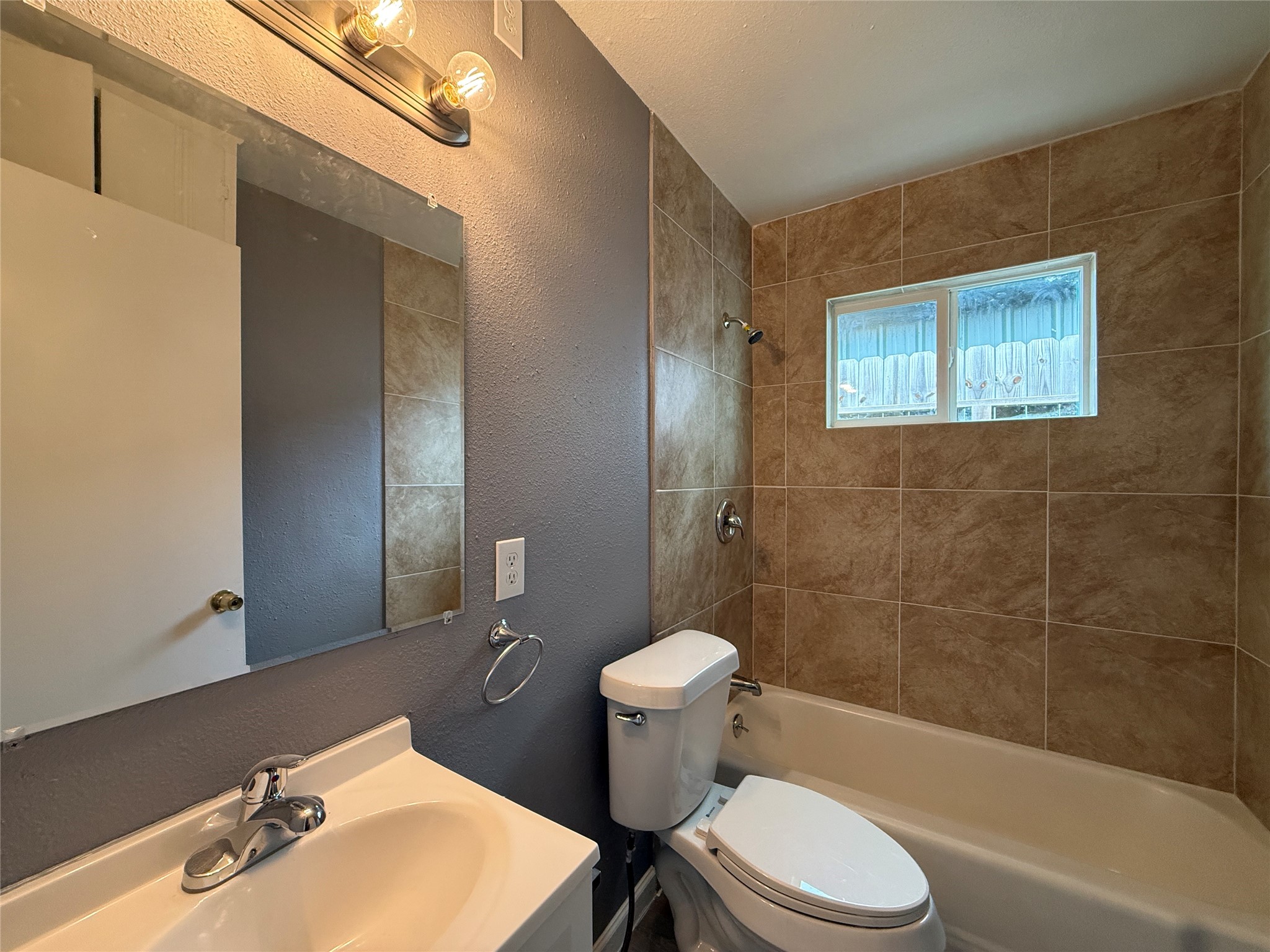8010 Roswell Street, Unit 3 Houston, TX 77022 - Photo 10 of 12 a bathroom with a sink toilet and shower