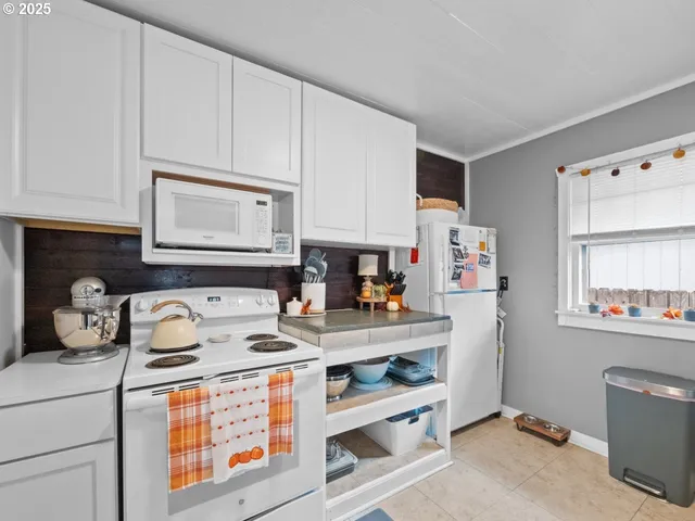 a utility room with dryer washer and a fridge