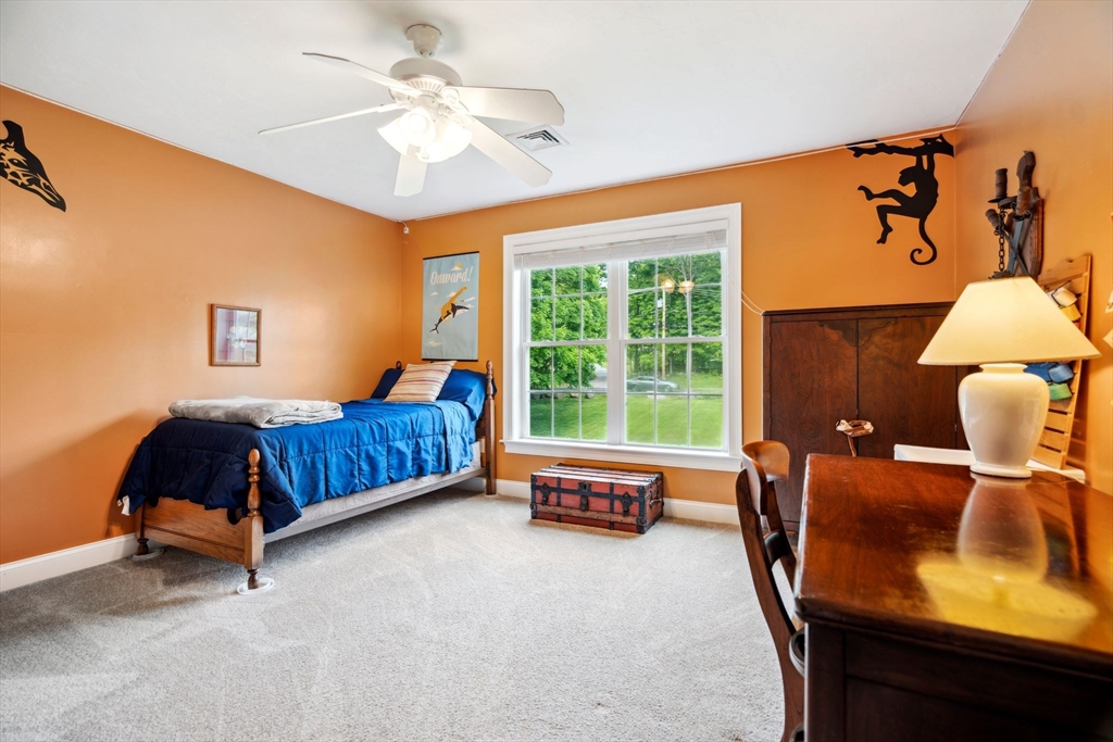 5 Maple Street Pepperell, MA 01463 - Photo 22 of 39 a bedroom with a bed and a lounge chair