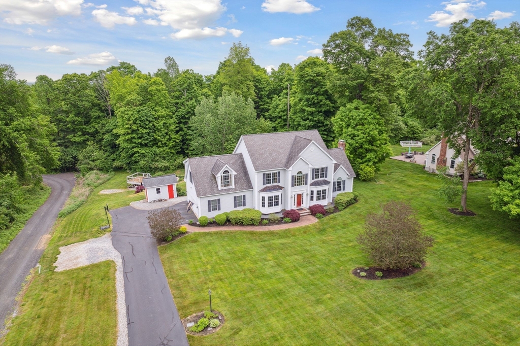 5 Maple Street Pepperell, MA 01463 - Photo 3 of 39 a aerial view of a house with a big yard and large trees